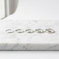 WCJ Barely-There 5-Piece Stacking Bands Set elegantly placed on white marble