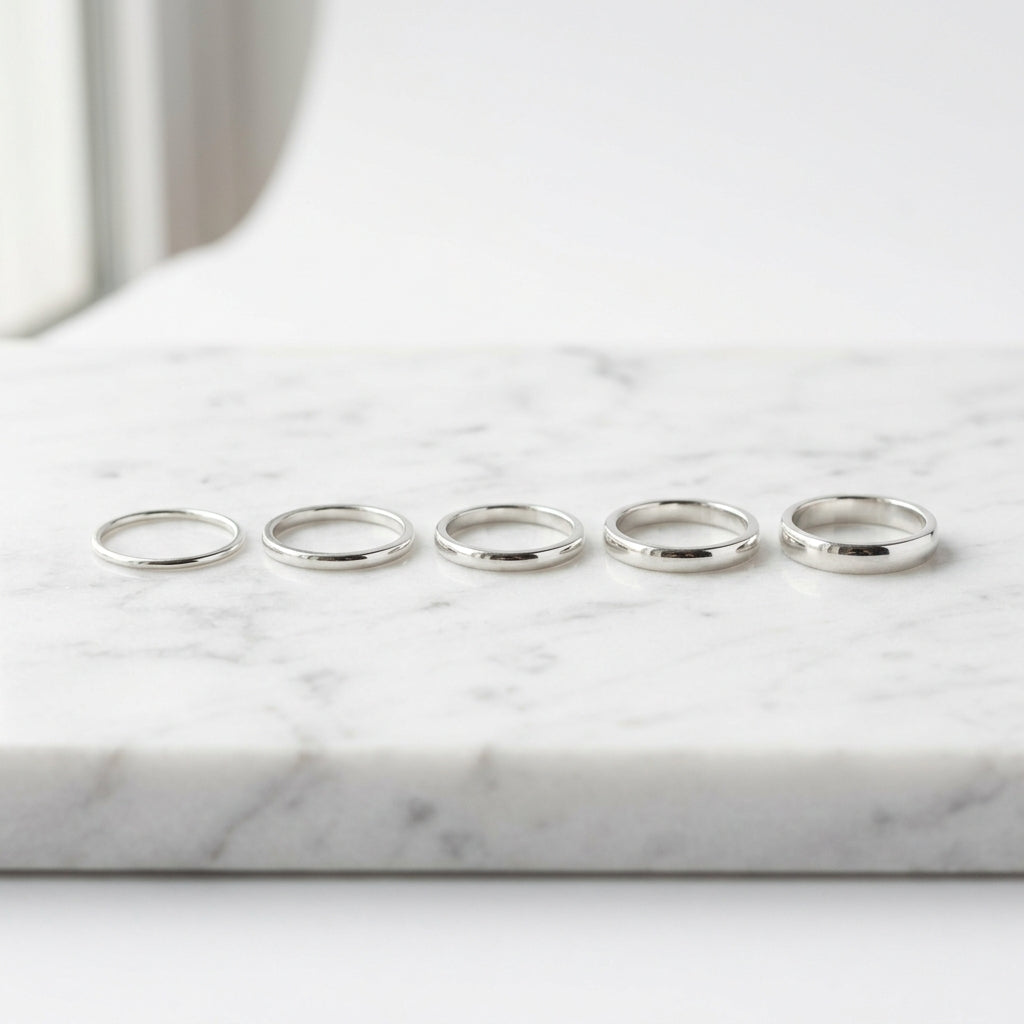 WCJ Barely-There 5-Piece Stacking Bands Set elegantly placed on white marble