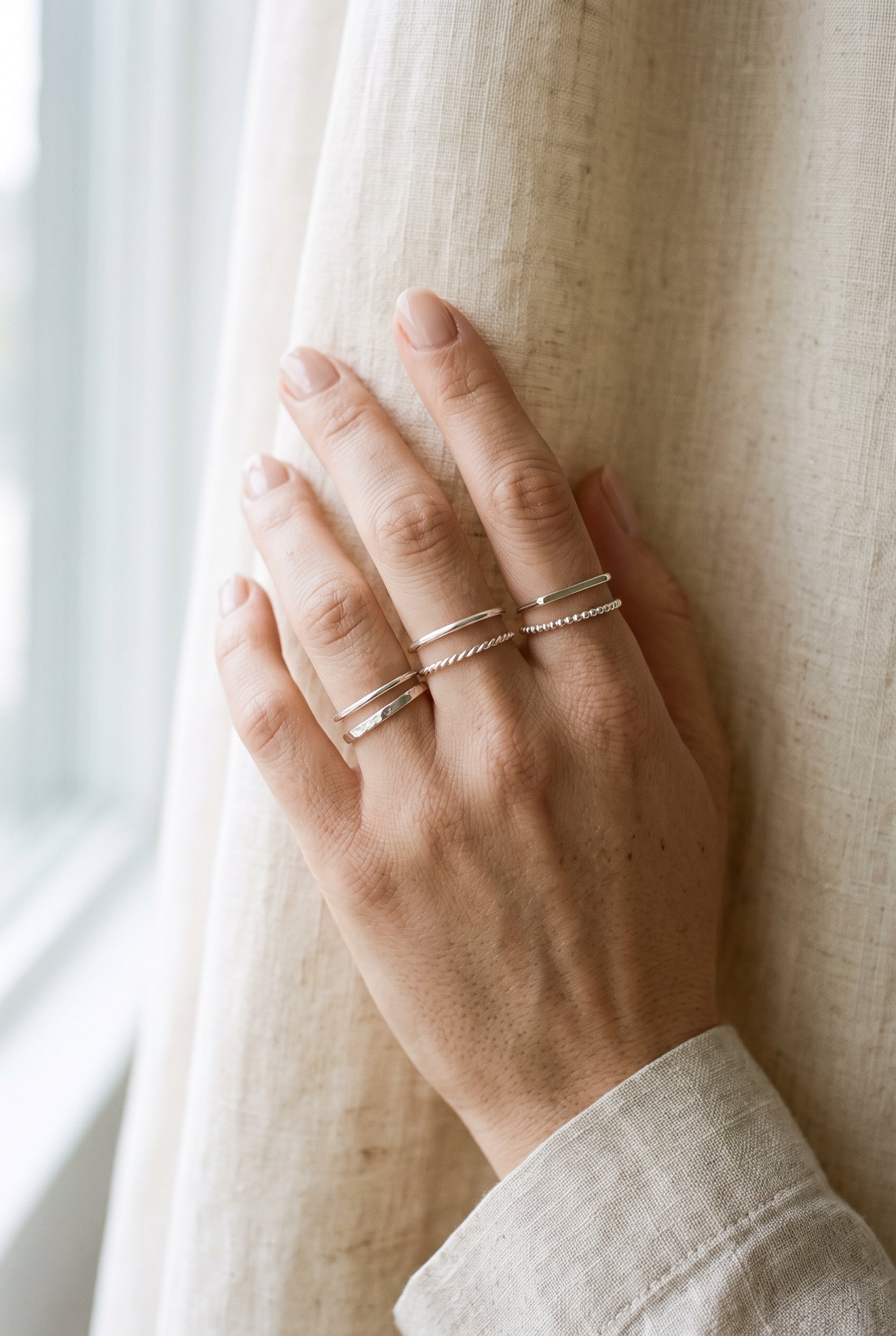 Hand model displaying WCJ Barely-There Stacking Bands Set